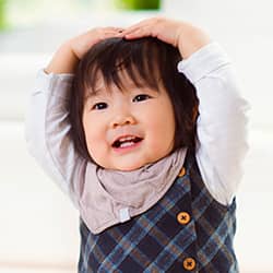 little girl with arms in air