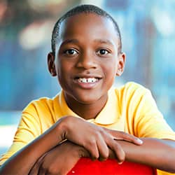 Boy smiling with arms crossed