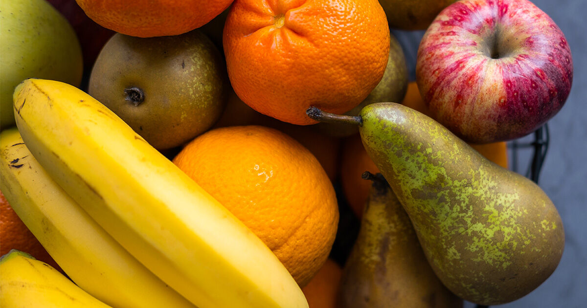 Healthy Snacks-Header-2 Assorted fresh fruit including bananas, oranges, pears, and an apple.